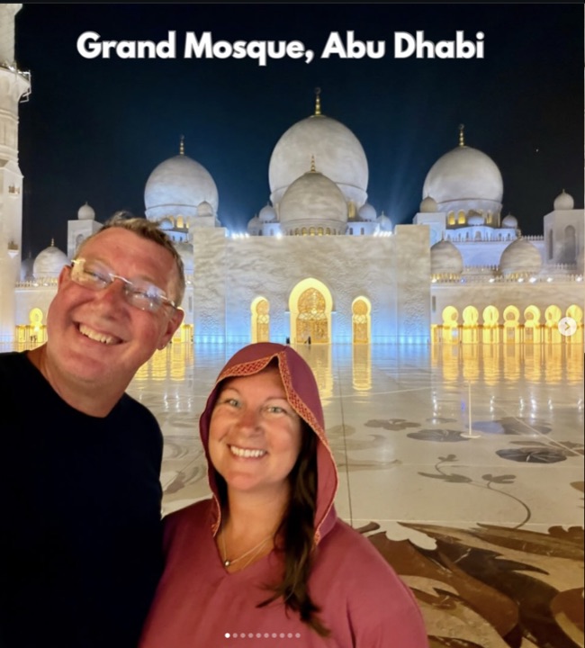 Aaron and Amanda at the Grand Mosque in Abu Dhabi, lit up at night